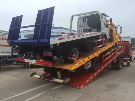 A flatbed carrying two trucks